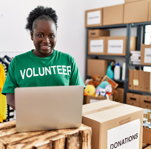 volunteer smiling while using laptop