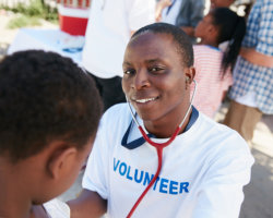 volunteer doctor examining a young patient