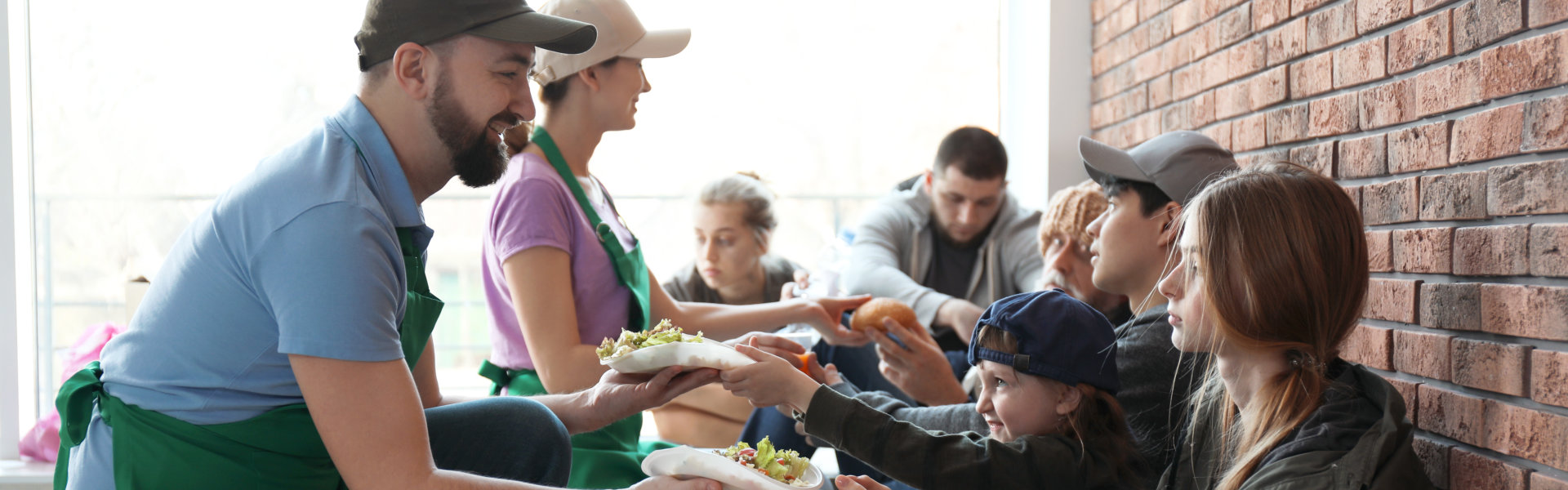 volunteers giving food to people