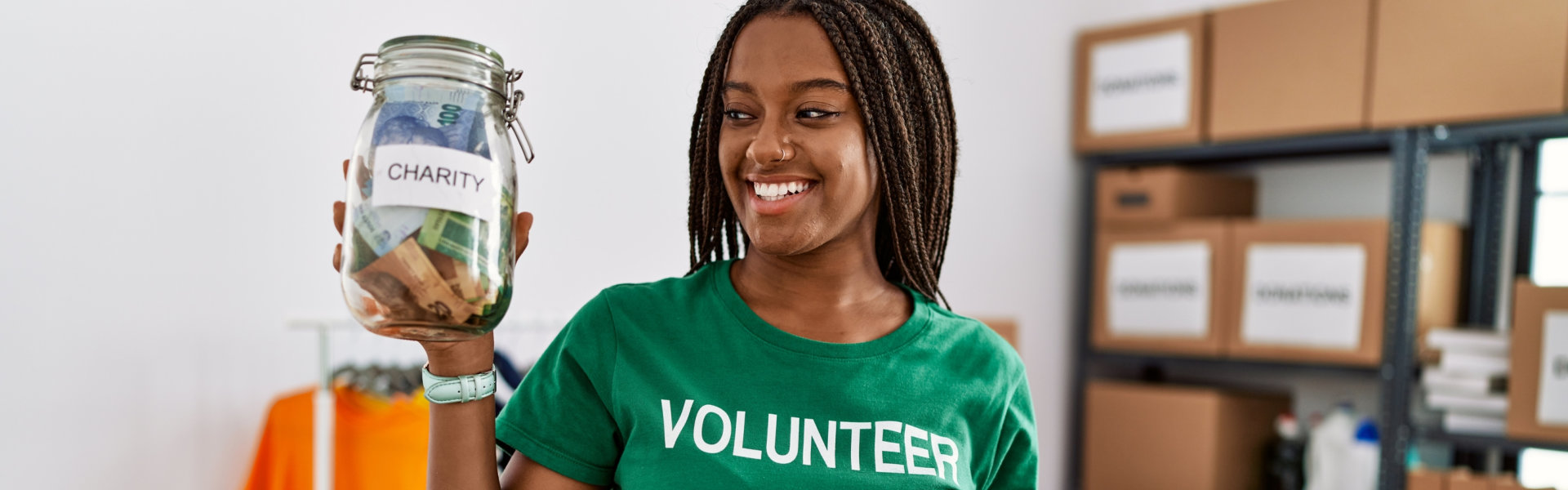 volunteer holding a jar